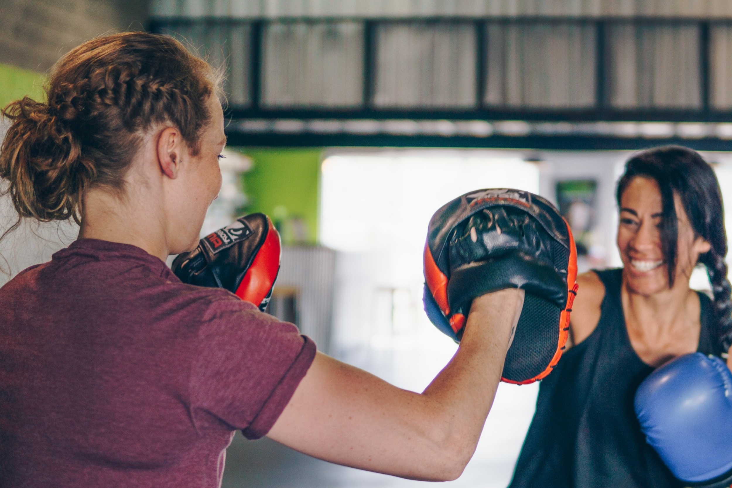A personal trainer conducting a boxing training session